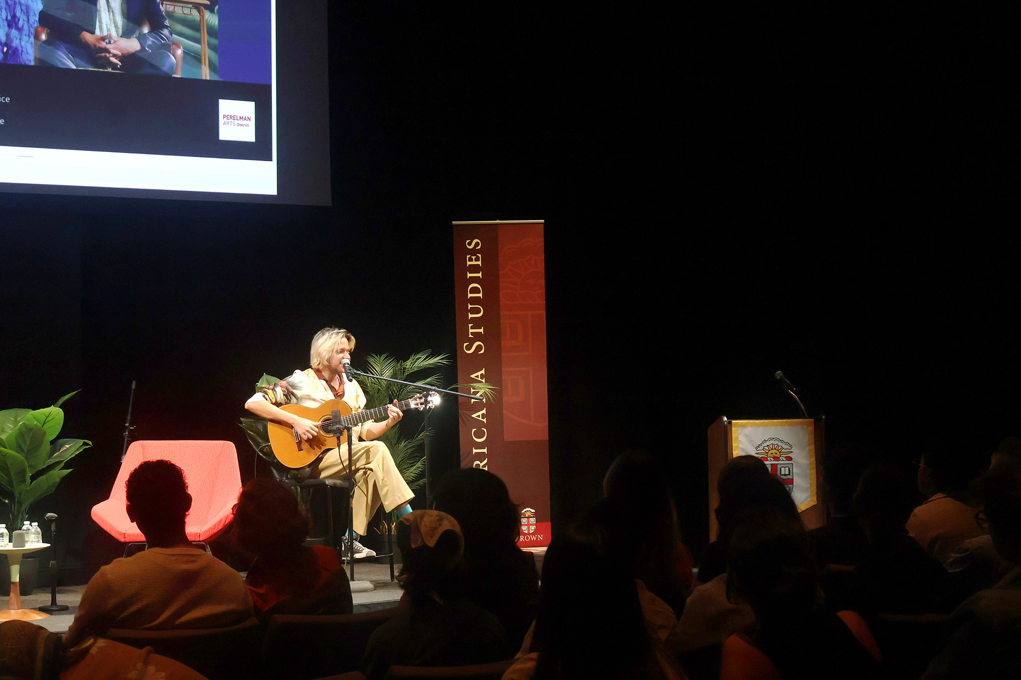 Someone playing guitar on a stage