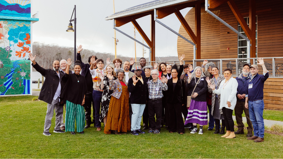 The Exhibition Committee pose and wave at the camera in front of the Entwined exhibition.
