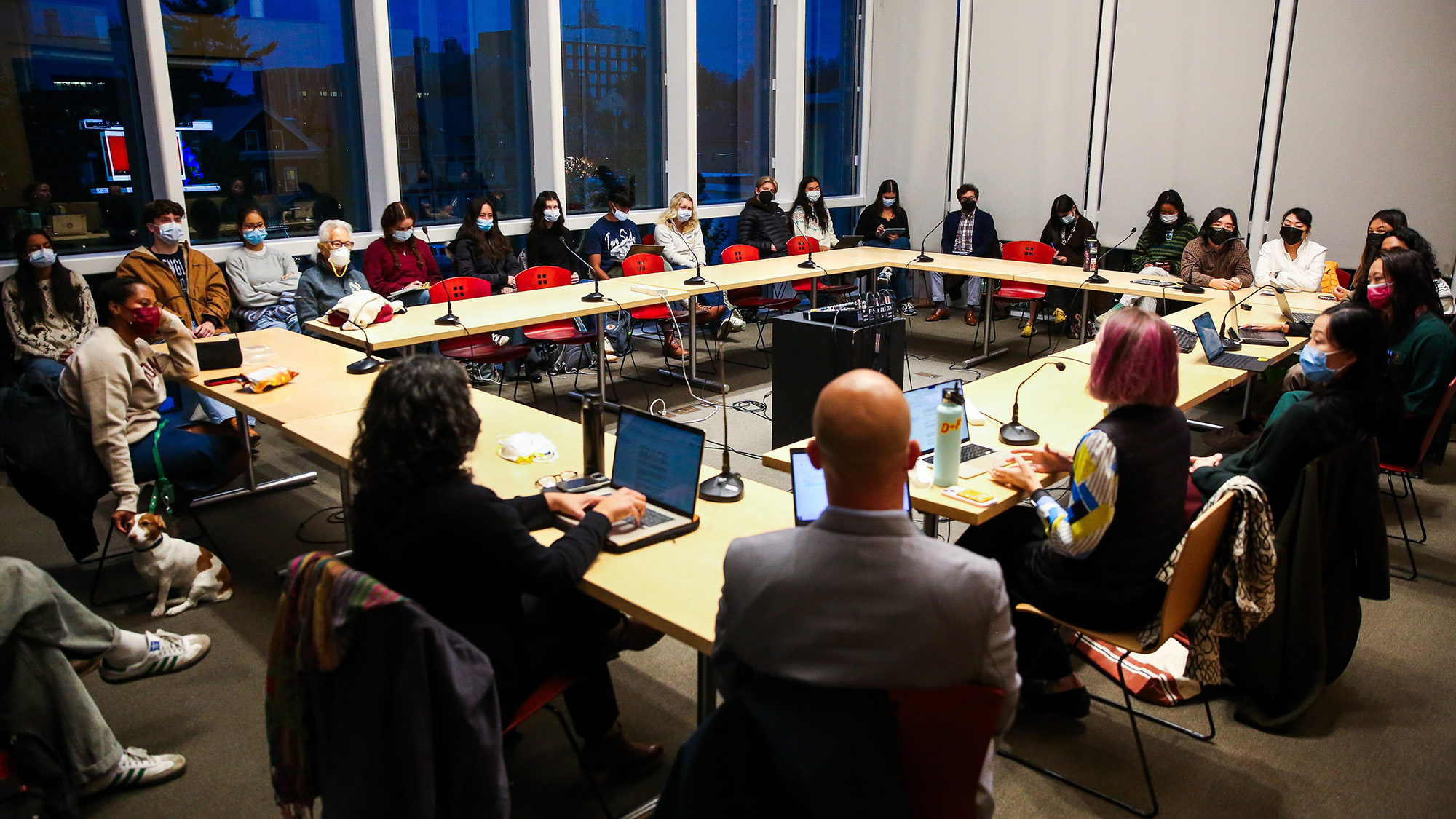 A group of people seated around a table talking