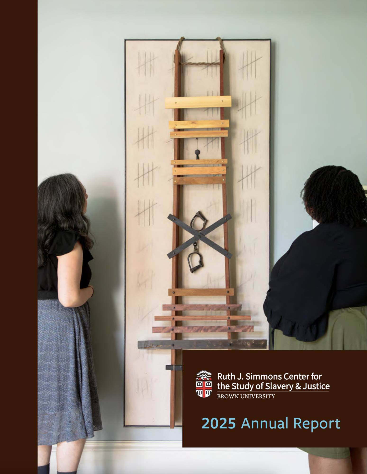 Picture of two women standing and looking at a piece of artwork on wall as cover of Simmons Center 2025 Annual Report