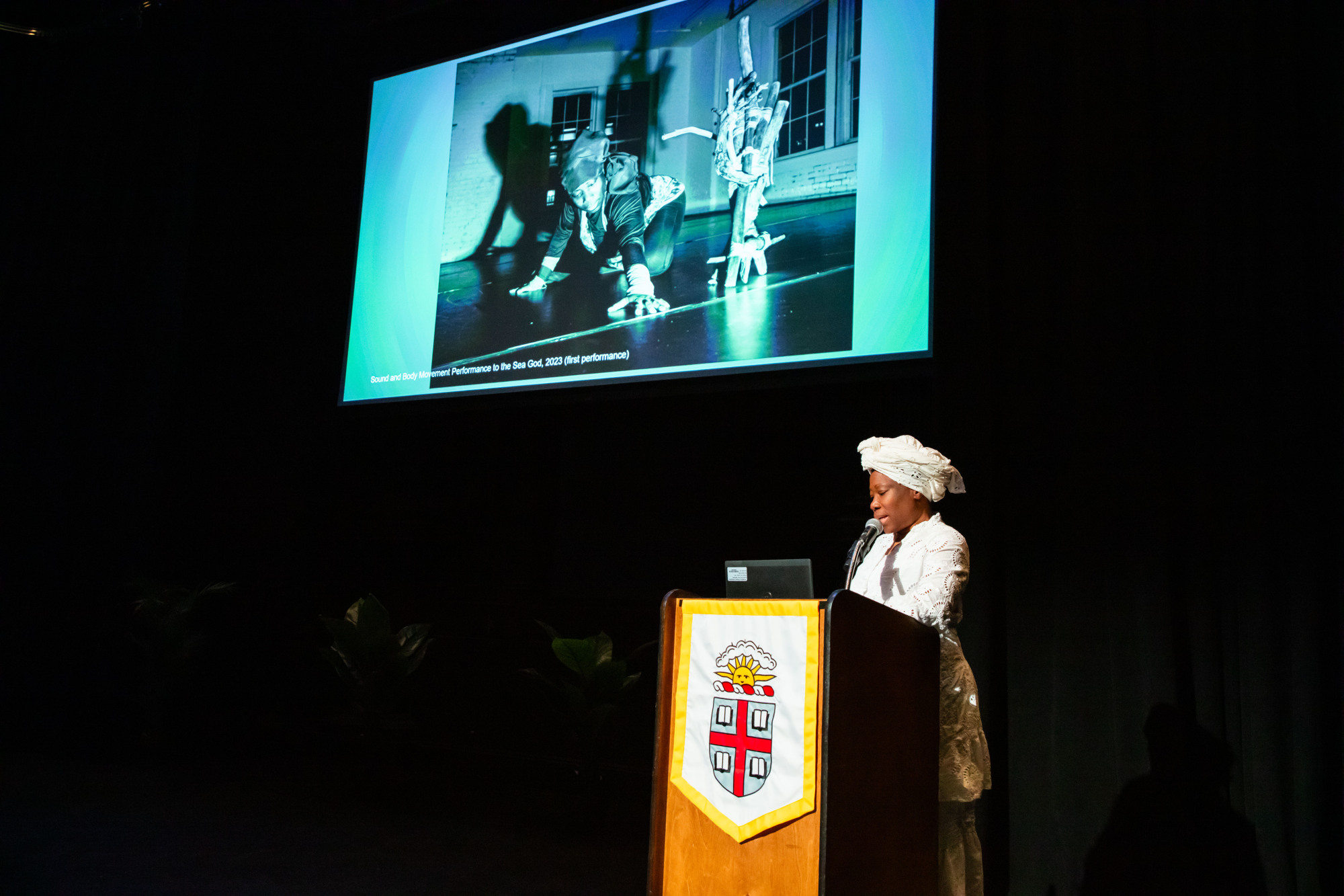 Woman speaking at a podium.