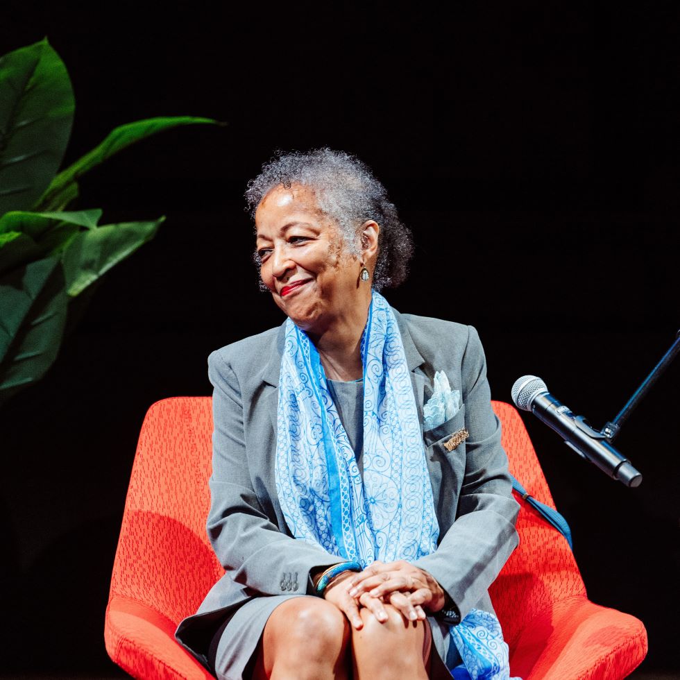 Prof. Geri Augusto seated for a panel event