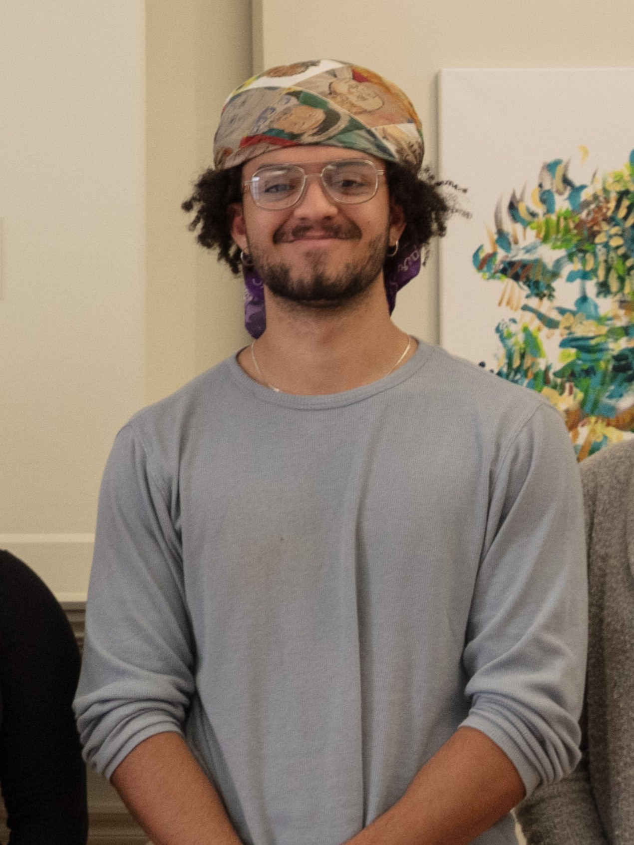 Man smiling and wearing a bandana.