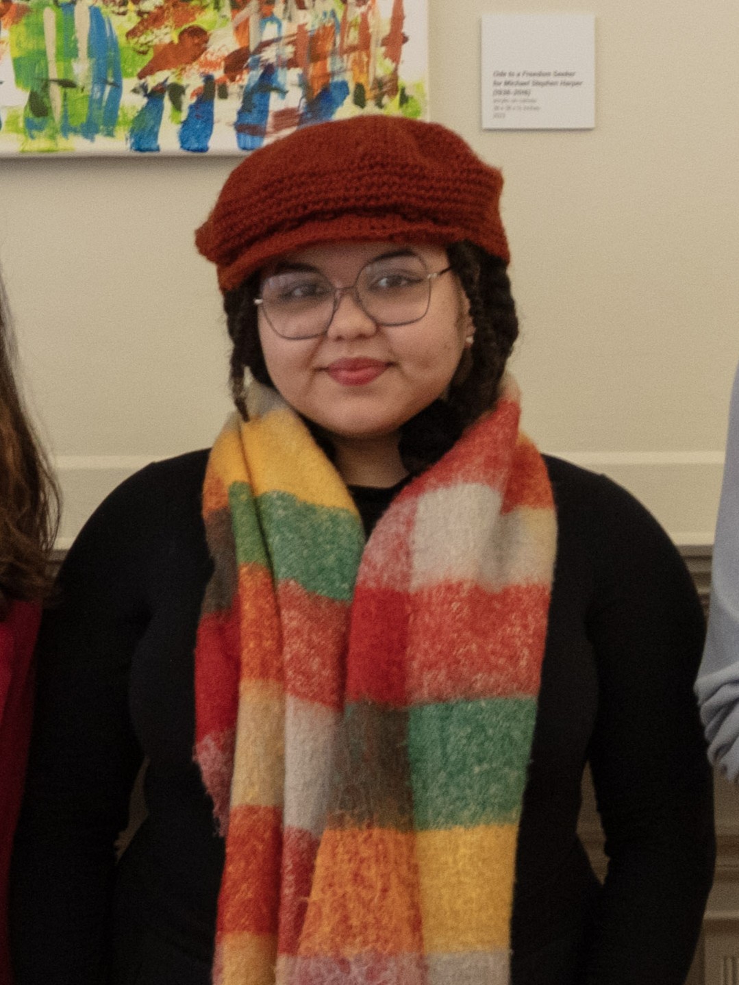 Woman wearing red hat and colorful scarf
