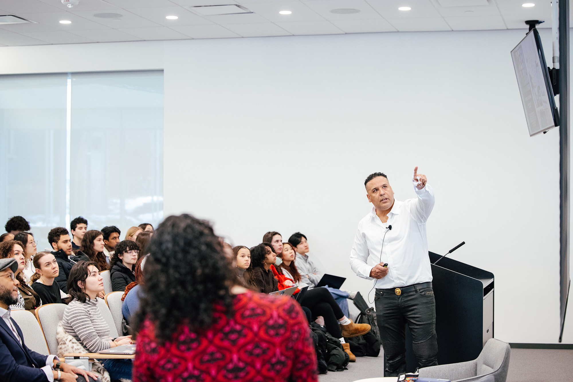 Someone giving an oral presentation to a group of people in the audience