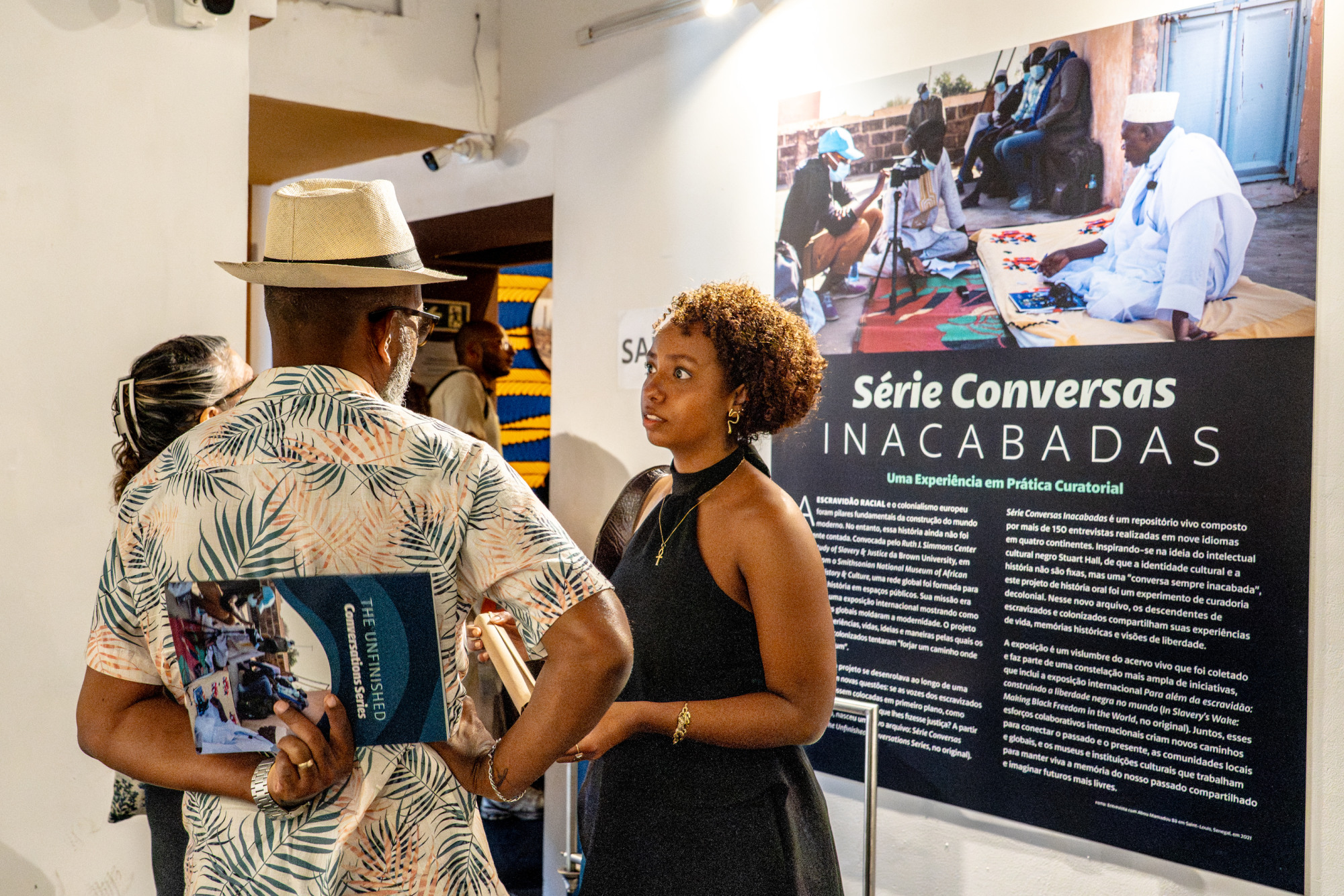 People gather and talk in the gallery exhibition
