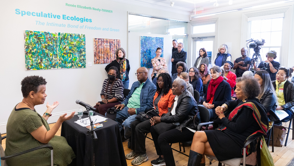 Artist speaks about her artwork and inspiration in the gallery