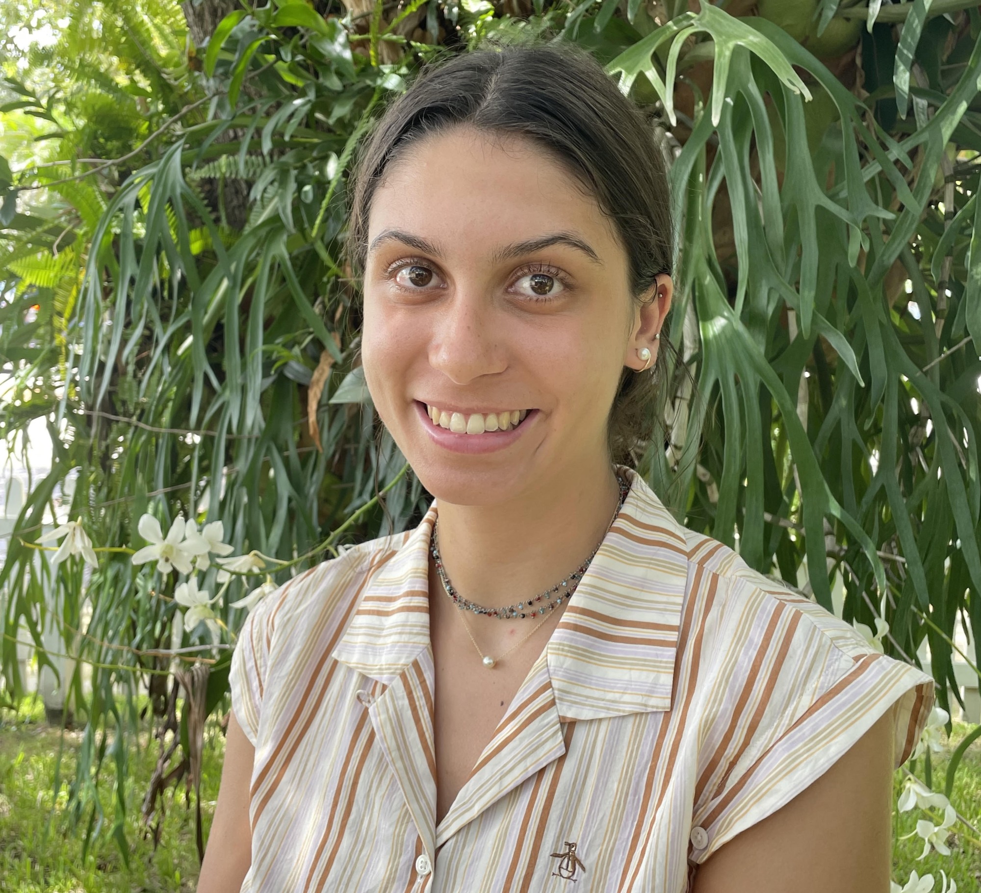 Headshot of Helena Evans in front of greenery.