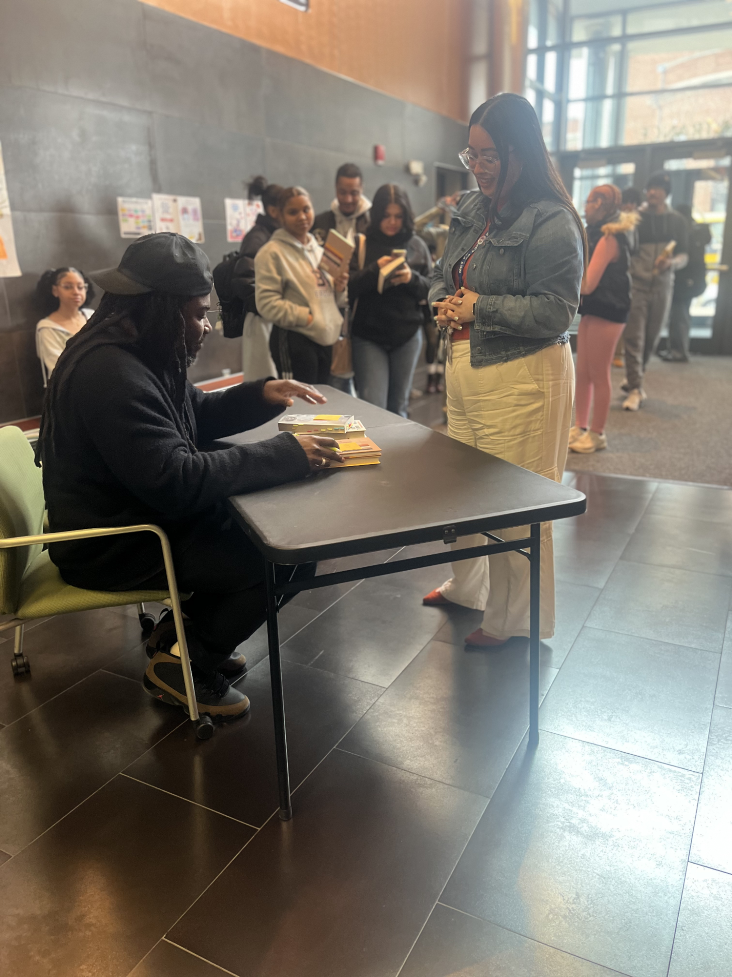 Line of people waiting for an author to sign their books.