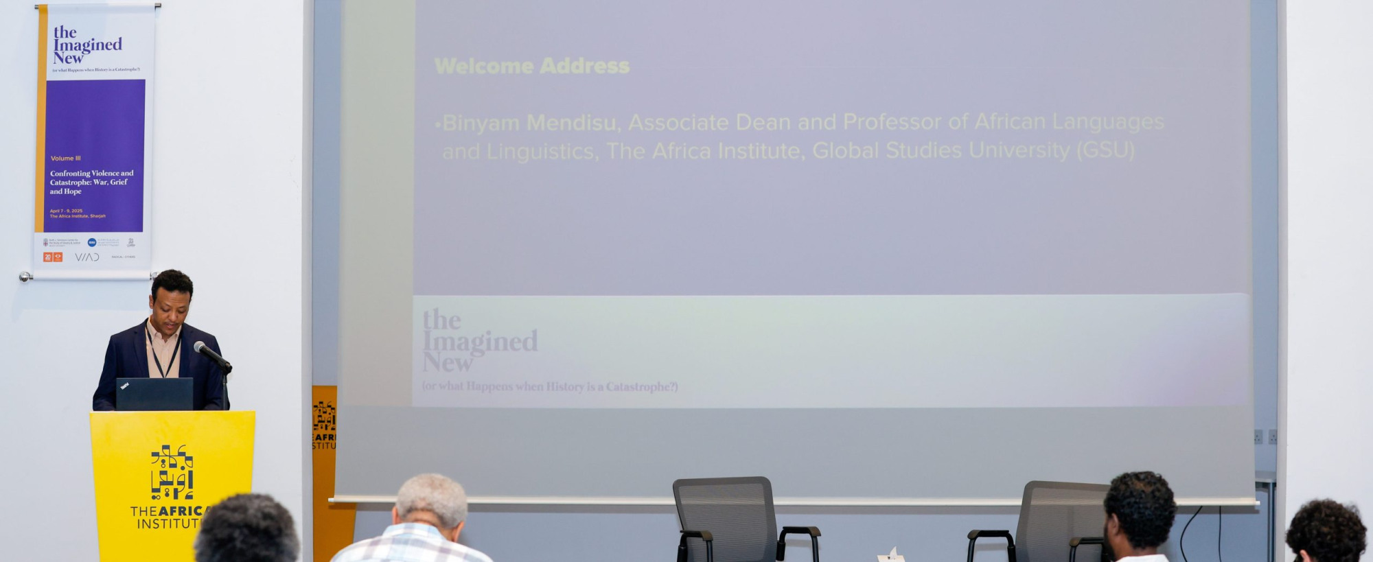 Man speaking at a podium presenting a presentation.