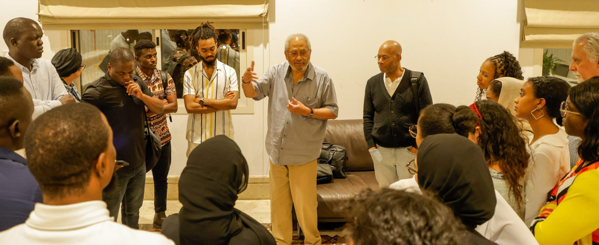 Group of people standing in a circle together.
