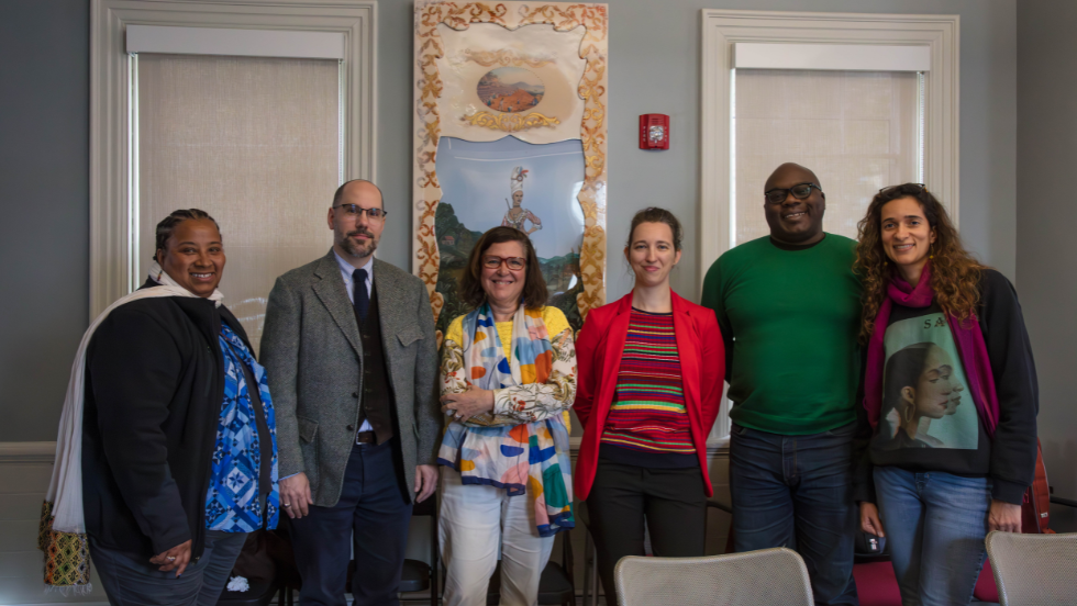 Six scholars gathered for an image in the Simmons Center conference room. 