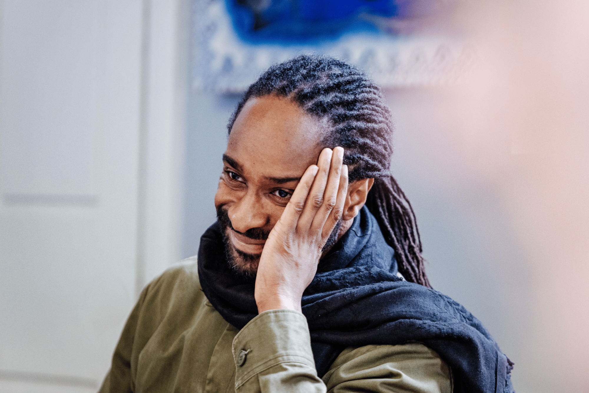 Man smiling with head in hand