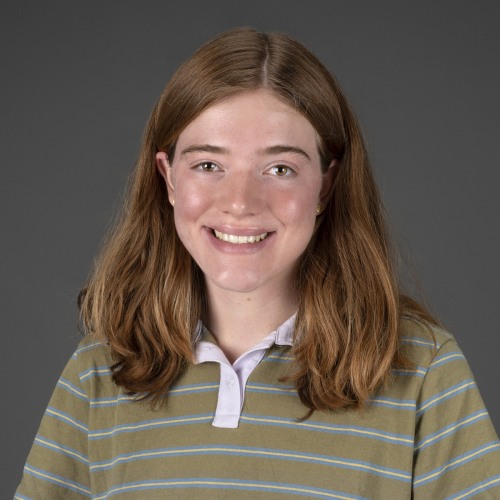 A woman with light brown hair smiles at the camera