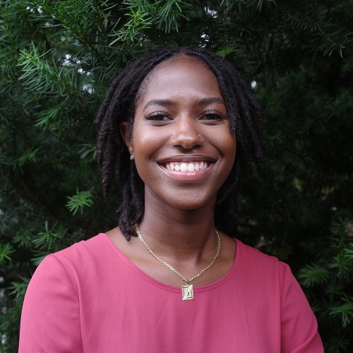 A woman smiles at the camera