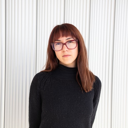 Christina Young with bangs and straight brown hair wearing glasses