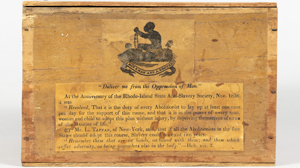 wooden box with pen and ink illustration of an enslaved person and text