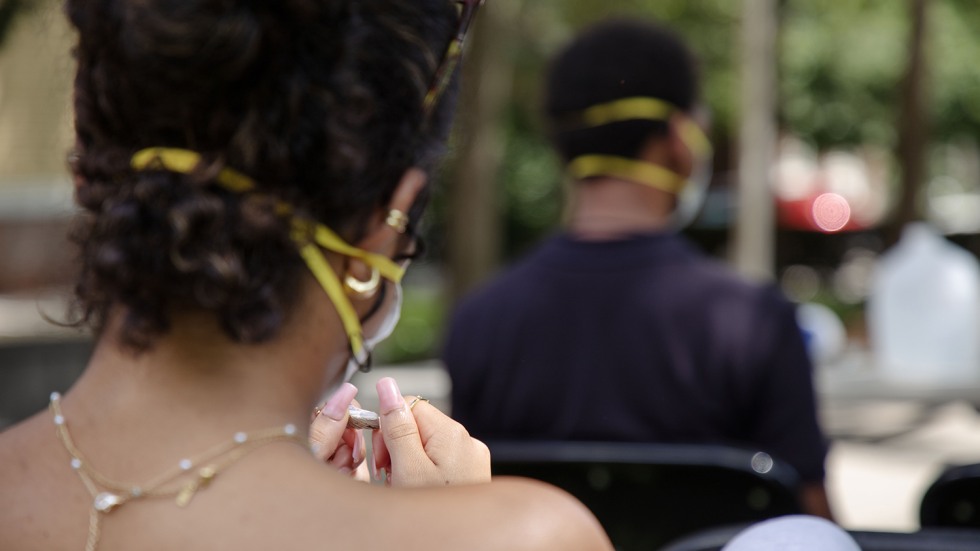 A student holds an examines a small piece of wampum