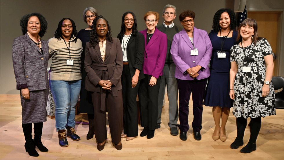 a large group of people who were part of the conference pose together on the stage