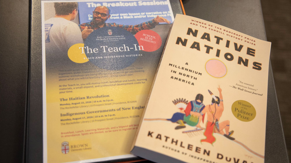 A 3-ring binder labeled The Teach-In with a book entitled Native Nations by Kathleen DuVal on top.